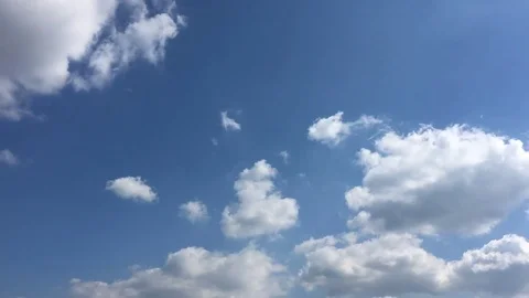White clouds disappear in the hot sun on blue sky. Time-lapse motion clouds blue Stock Footage 76843274