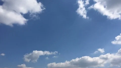White clouds disappear in the hot sun on blue sky. Time-lapse motion clouds blue Stock Footage 76843283