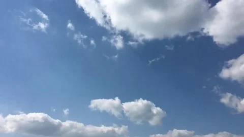 White clouds disappear in the hot sun on blue sky. Time-lapse motion clouds blue Stock Footage 76843923