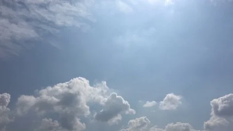 White clouds disappear in the hot sun on blue sky. Time-lapse motion clouds blue Stock Footage 76844332