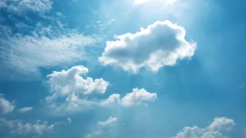 White clouds disappear in the hot sun on blue sky. Time-lapse motion clouds blue Stock Footage 76844487
