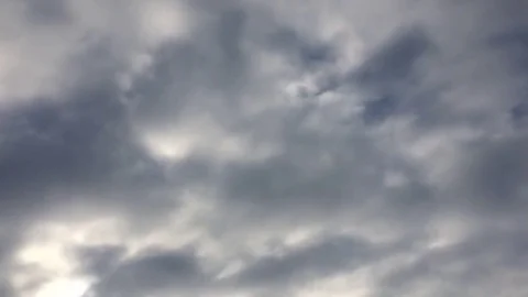 White clouds disappear in the hot sun on blue sky. Time-lapse motion clouds blue Stock Footage