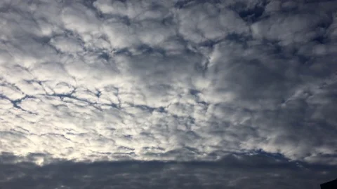 White clouds disappear in the hot sun on blue sky. Time-lapse motion clouds blue Stock Footage