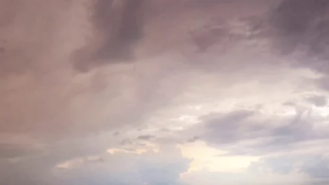 White clouds disappear in the hot sun on blue sky. Time-lapse motion clouds blue Stock Footage
