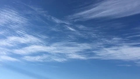 White clouds disappear in the hot sun on blue sky. Time-lapse motion clouds blue Stock Footage 91341695