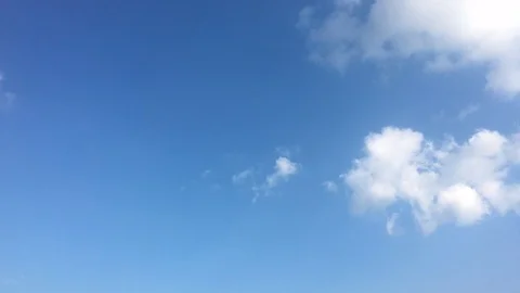 White clouds disappear in the hot sun on blue sky. Time-lapse motion clouds blue Stock Footage 92231664