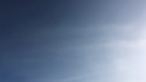 White clouds disappear in the hot sun on blue sky. Loop features time lapse moti Video stock 98121738