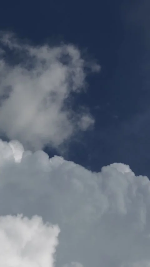 White clouds drift fast across deep blue sky in timelapse. Stock Footage 340902357