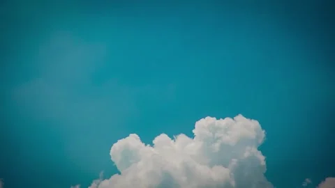 White clouds drifting across bright blue skyline. Video stock 335712694
