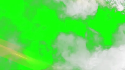 White clouds drifting across a vibrant green screen background with soft golden Stock Footage 339123643