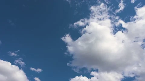 White clouds drifting through a rich blue sky. Stock Footage 155169100