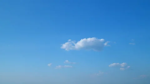 White clouds float across the blue sky. Puffy fluffy soft clouds. Timelapse. Stock Footage 219263806