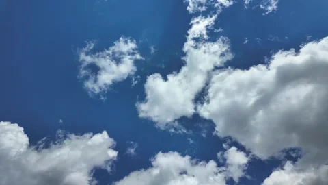 White clouds float across the blue sky. Puffy fluffy soft clouds. Timelapse Stock Footage 337901046