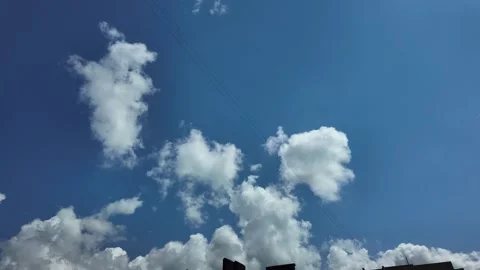 White clouds float across the blue sky. Puffy fluffy soft clouds. Timelapse Stock Footage 339068515