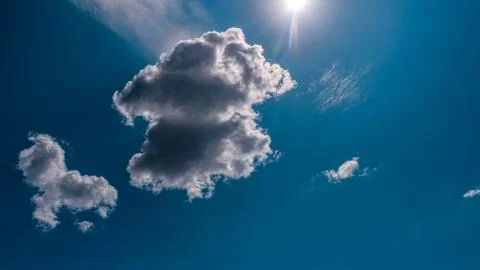 White clouds float across the blue sky Stock Photos