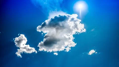 White clouds float across the blue sky Stock Photos