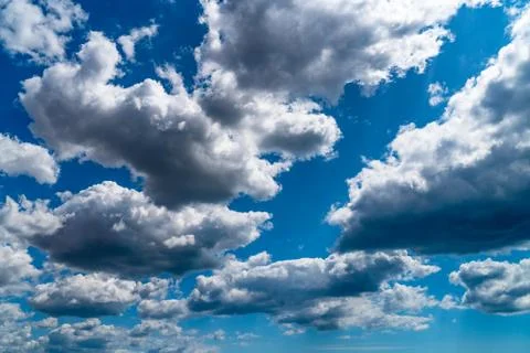 White clouds float across the blue sky Stock Photos