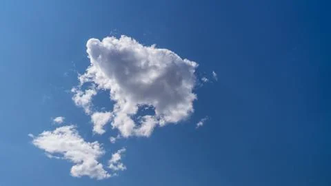 White clouds float across the blue sky Stock Photos