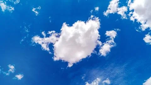 White clouds float across the blue sky Stock Photos