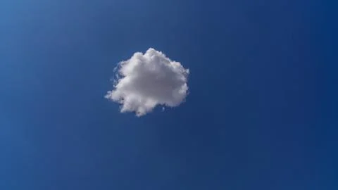 White clouds float across the blue sky Stock Photos