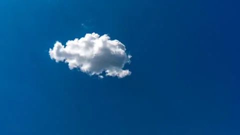 White clouds float across the blue sky Stock Photos