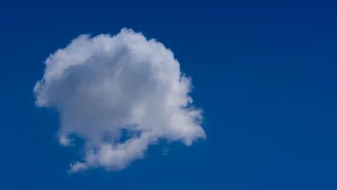 White clouds float across the blue sky Foto stock