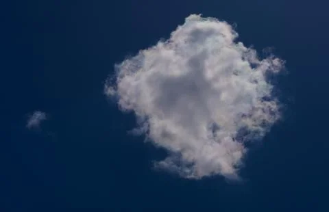 White clouds float across the blue sky Stock Photos