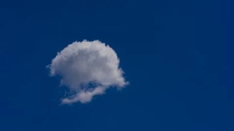 White clouds float across the blue sky Stock Photos