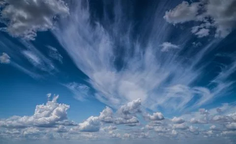 White clouds float across the blue sky Stock Photos