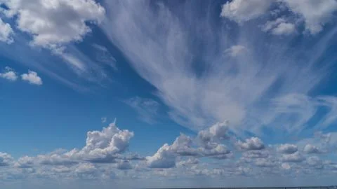 White clouds float across the blue sky Stock Photos