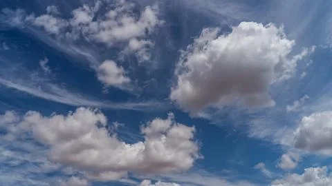 White clouds float across the blue sky Stock Photos