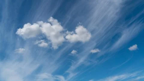 White clouds float across the blue sky Stock Photos