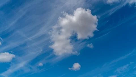 White clouds float across the blue sky Stock Photos