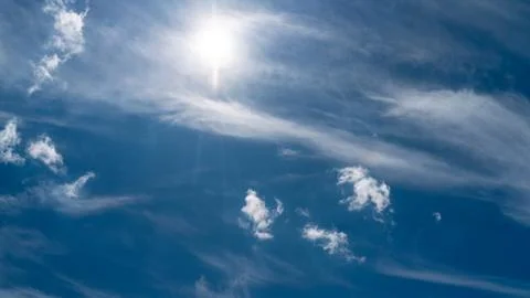White clouds float across the blue sky Stock Photos