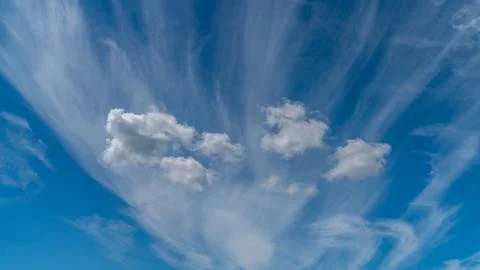 White clouds float across the blue sky Stock Photos