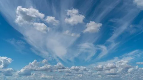 White clouds float across the blue sky Stock Photos