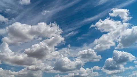 White clouds float across the blue sky Stock Photos