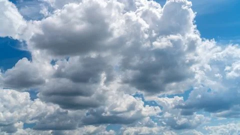 White clouds float across the blue sky Stock Photos