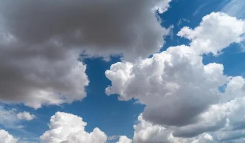 White clouds float across the blue sky Stock Photos
