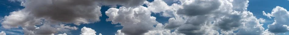 White clouds float across the blue sky Stock Photos