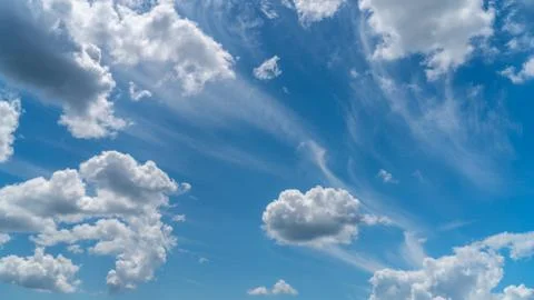 White clouds float across the blue sky Stock Photos