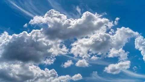 White clouds float across the blue sky Stock Photos