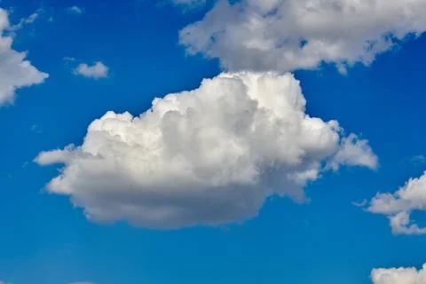 White clouds float across the blue sky Stock Photos