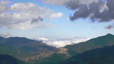 White clouds float across the sky over the mountains. Stock Footage 152716083