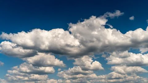 White clouds float across the sky Stock Photos