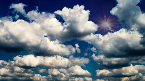 White clouds float across the sky Stock Photos