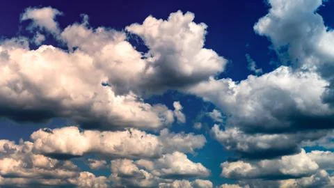 White clouds float across the sky Stock Photos