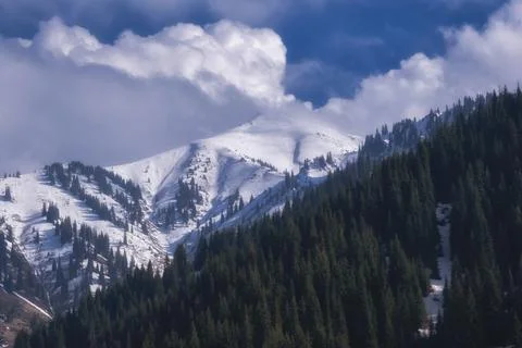 White clouds, float beautifully over snow covered mountain peak, beautiful mo Fotos de archivo