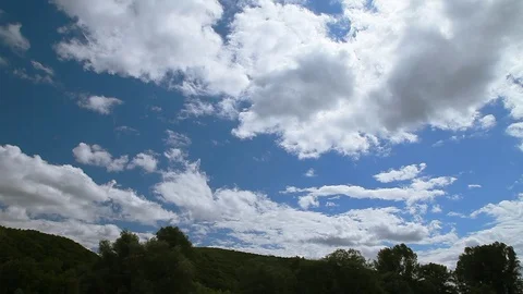 White clouds float on the blue sky. Fast movement Stock Footage 77911644