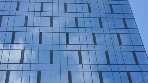 White clouds float on blue sky reflecting in windows Stock-Footage 135859005